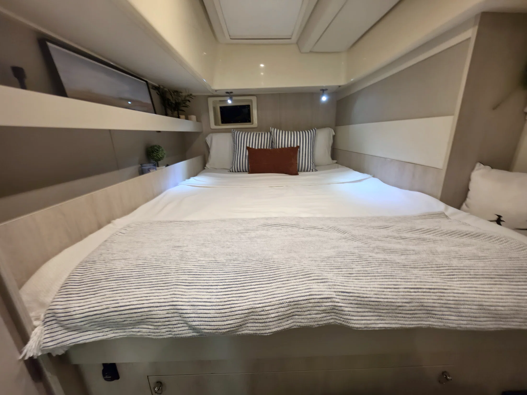 Private guest suite aboard Freebird with a made bed and built-in cabinetry