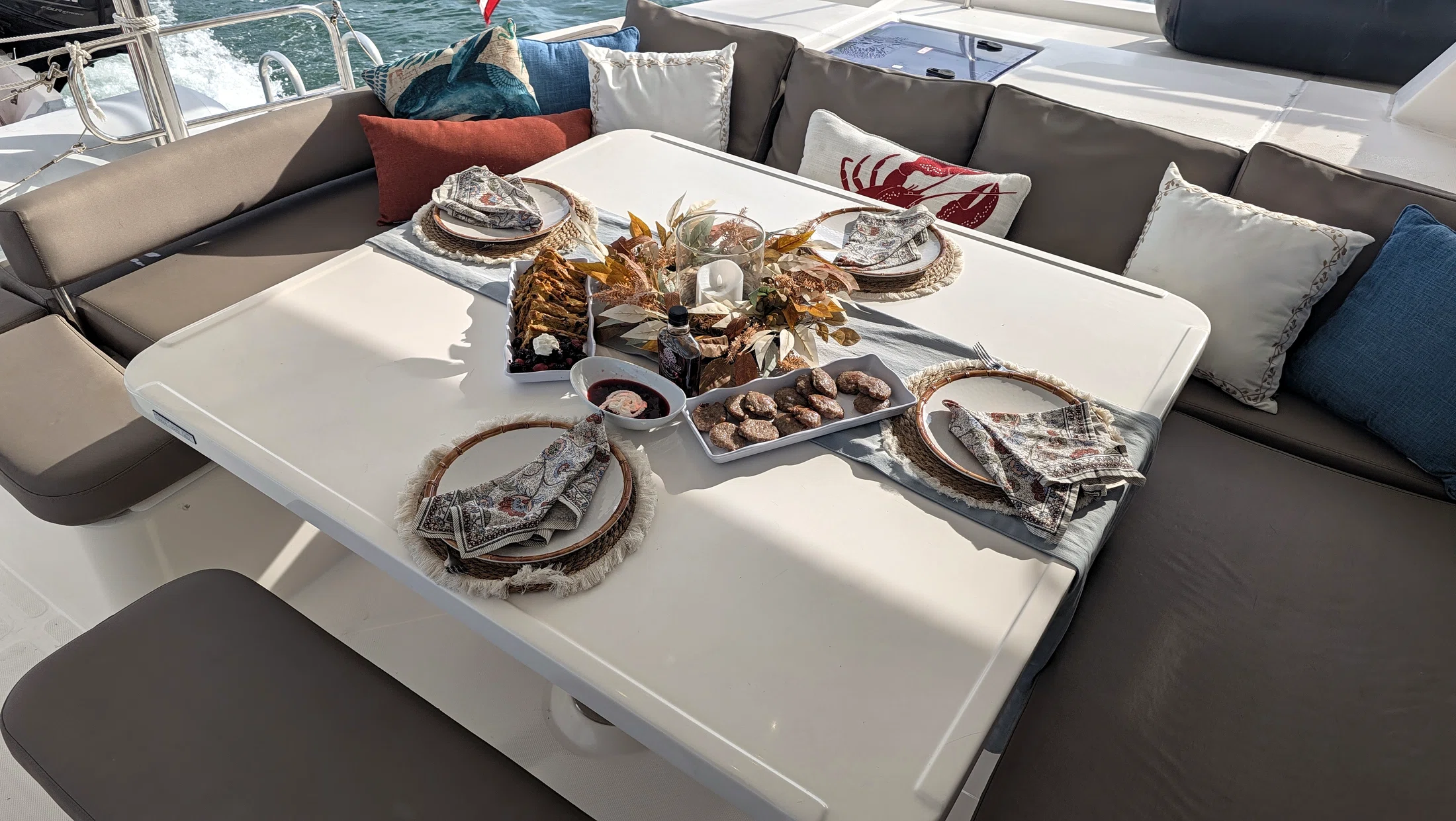 Meal spread in the aft lounge aboard Freebird with the water beyond