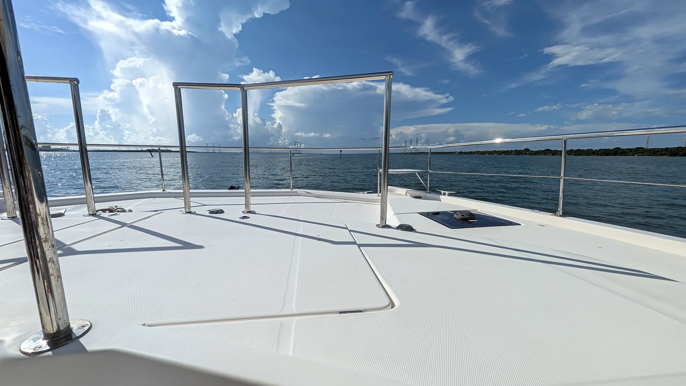 Foredeck of Freebird beneath a bright coastal sky