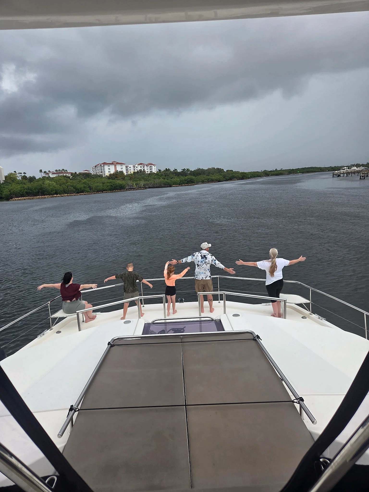 Family group enjoying time together on the bow of Freebird